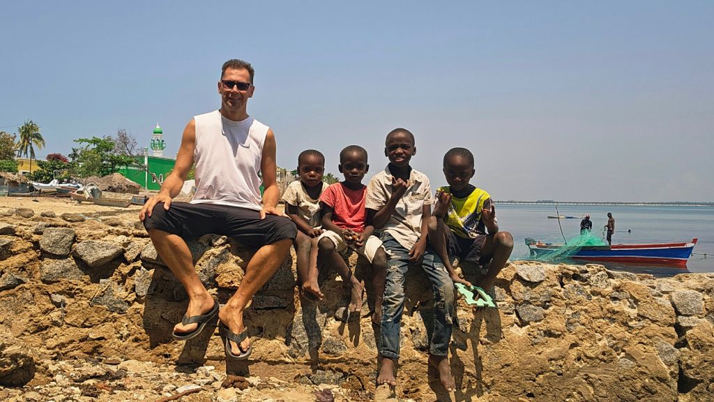 Rok and group of kids posing happily on the Island of Mozambique, Mozambique