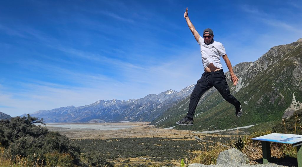 Rok leaping with mountain backdrop in Mount Cook National Park, New Zealand