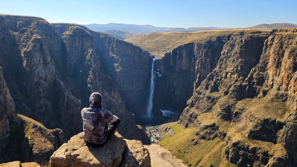 Rok admiring Maletsunyane Falls cascading down a steep mountain cliff, Lesotho