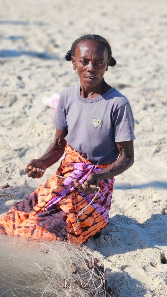 Woman knitting a fishing net in Morondava, Madagascar